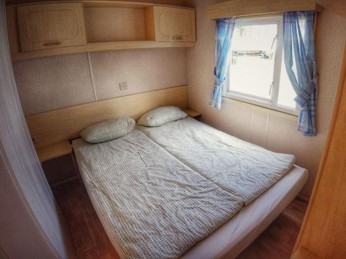 a small bed in a small room with a window at Holiday Home Prima by Interhome in Prague