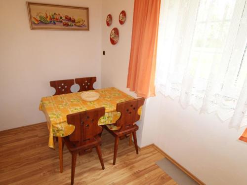 a dining room with a table and chairs and a window at Holiday Home Vlhlavy u Hluboké by Interhome in Sedlec