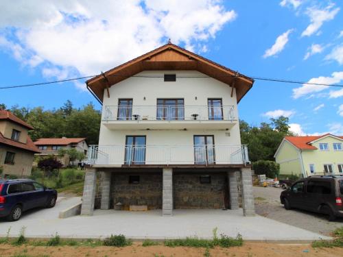 a large white house with a gambrel roof at Apartment Županovice-3 by Interhome in Dobříš
