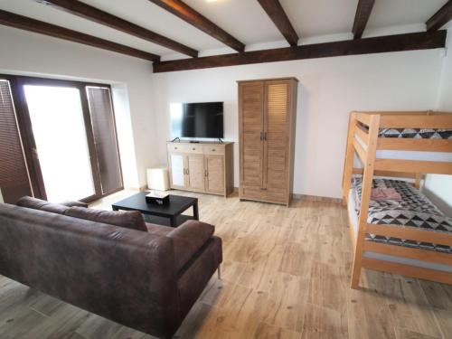 a living room with a couch and a bunk bed at Apartment Županovice-3 by Interhome in Dobříš