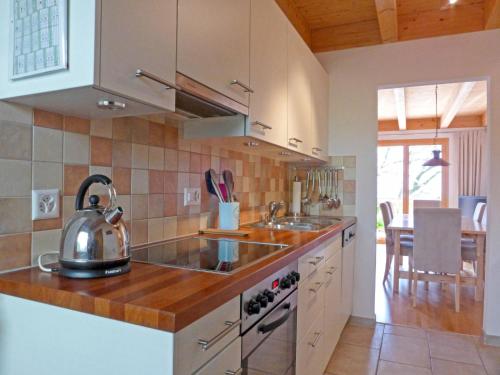 a kitchen with a tea kettle on a counter at Apartment Racer's Retreat Apt-2 by Interhome in Wengen