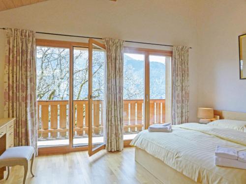 a bedroom with a bed and a large window at Apartment Racer's Retreat Apt-2 by Interhome in Wengen