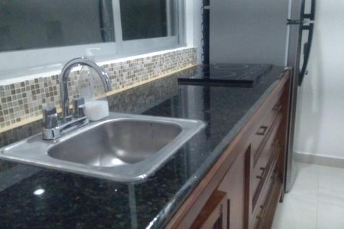 Kuchyň nebo kuchyňský kout v ubytování Apartmento con alberca a 50 mt del mar La Licha