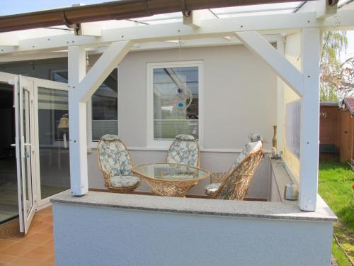 a patio with a table and chairs on a house at Holiday Home Philipp by Interhome in Loissin