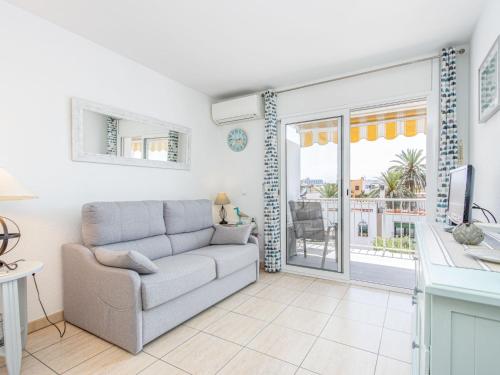 a living room with a couch and a balcony at Apartment Pattaya-10 by Interhome in Empuriabrava