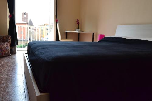 a bedroom with a large bed and a window at You & Me in Pisa