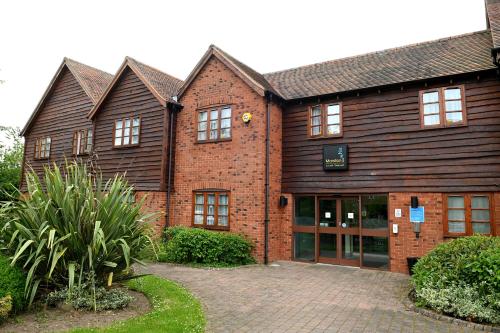 a large brick building with a driveway in front of it at Meadow Farm Redditch by Marstons Inns in Redditch