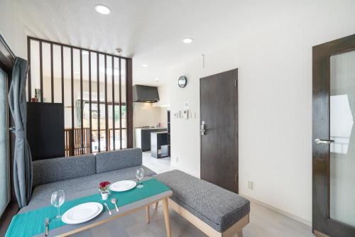 a living room with a couch and a table at Otsuka house with 2BR near the Yamanote line in Tokyo