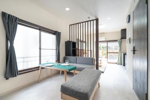 a living room with a table and a couch at Otsuka house with 2BR near the Yamanote line in Tokyo