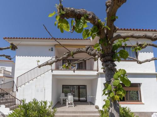 a white house with a tree in front of it at Apartment L'Estel by Interhome in Torredembarra