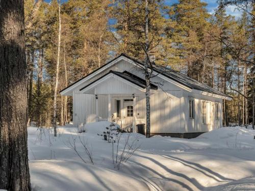 a small white shed in the snow with trees at Holiday Home Huvikumpu by Interhome in Hailuoto