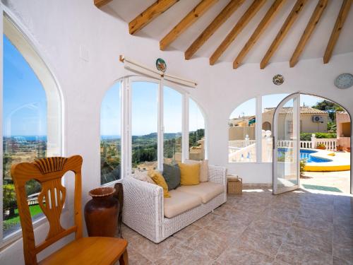 un soggiorno con divano e vista sulla piscina di Holiday Home Castellons Vida by Interhome a Teulada