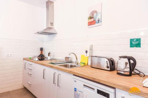 a kitchen with a sink and a counter top at Casa Rehala by Cadiz Time in Cádiz