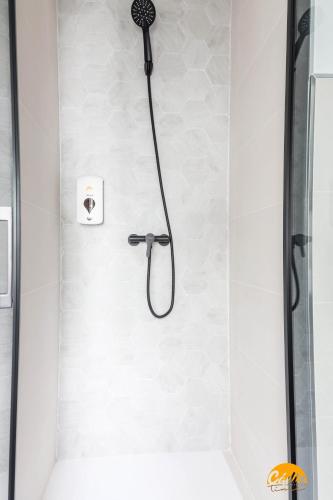 a shower with a black shower head in a bathroom at Casa Rehala by Cadiz Time in Cádiz