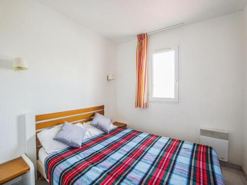 - une chambre avec un lit et une couverture colorée dans l'établissement Apartment Primavera-1 by Interhome, au Cap d'Agde