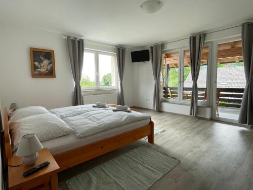 a bedroom with a bed and a large window at Apartments B&S in Bled