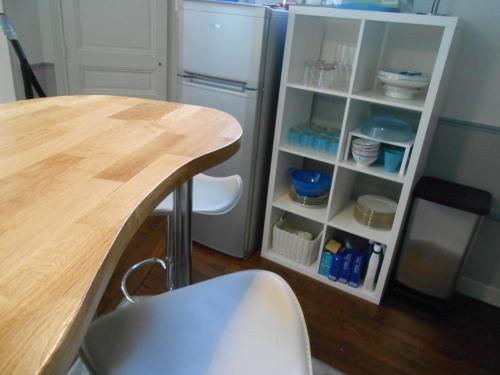 a kitchen with a table and a refrigerator at Apartment Lourmel in Paris