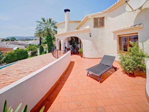 a patio of a house with a chair on a roof at Apartment Doris by Interhome in Calpe
