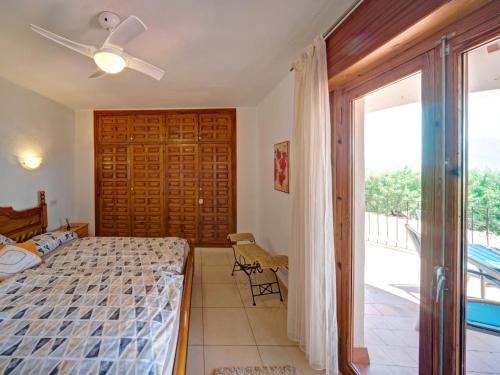 a bedroom with a bed and a sliding glass door at Apartment Doris by Interhome in Calpe