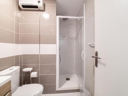 a small bathroom with a toilet and a shower at Apartment Les Héliades-2 by Interhome in Cap d'Agde