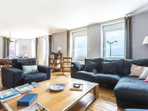 a living room with a couch and a table at Apartment La Vigie by Interhome in Cancale