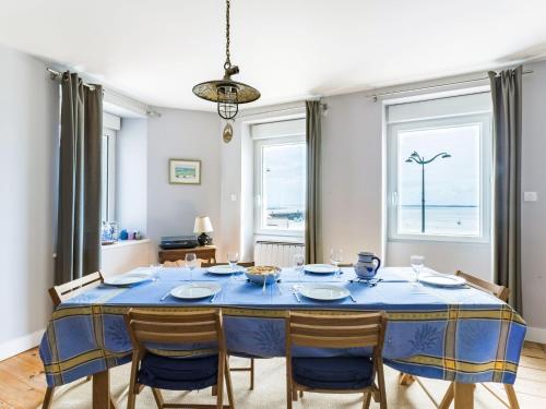 a dining room with a blue table and chairs at Apartment La Vigie by Interhome in Cancale