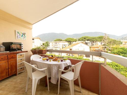 a balcony with a table and chairs on a balcony at Studio Le Grand Foc-3 by Interhome in Cavalaire-sur-Mer