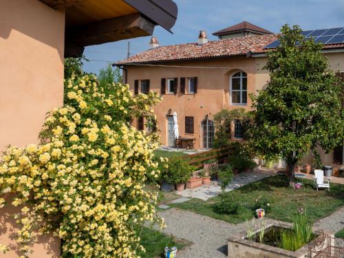 una casa con flores amarillas delante de un patio en Holiday Home Casa Vicentini by Interhome, en Alfiano Natta