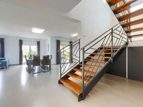 a staircase in a home with a living room and a table at Holiday Home Villa Lea by Interhome in Šišan