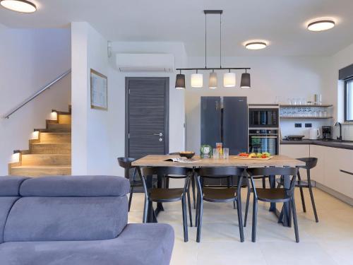 a kitchen and dining room with a table and chairs at Villa Tara by Interhome in Medulin