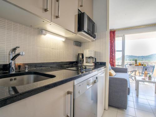 une cuisine avec un évier et un plan de travail dans l'établissement Apartment L'Esquinade P1 111 by Interhome, à Agay