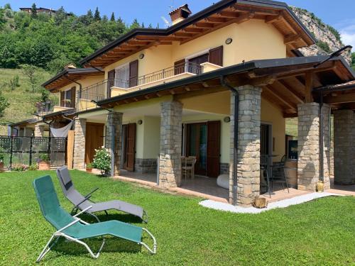 a house with a chair in the yard at Holiday Home Aaron by Interhome in Tremosine Sul Garda