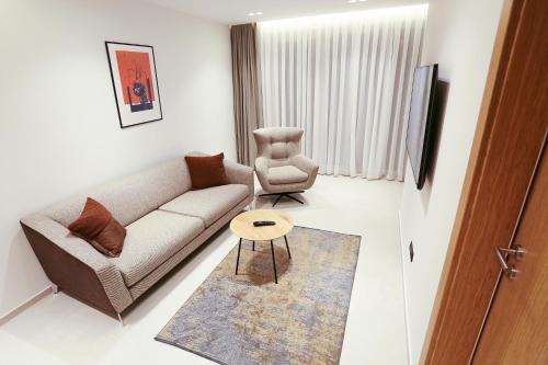 a living room with a couch and a chair at HOTEL 12 in Gjakove