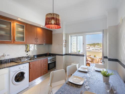 a kitchen with a table and a dining room at Apartment Capital 4 You by Interhome in Portimão