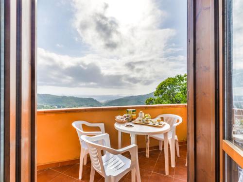 a table and chairs on a balcony with a view at Apartment Terrazza di Paolo by Interhome in Rio nellʼElba