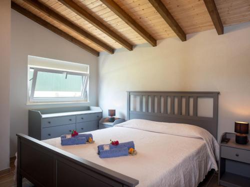 a bedroom with a bed with two blue boxes on it at Villa Sintra-Riviera by Interhome in Sintra