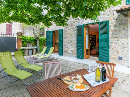 a table with a plate of food on a patio at Holiday Home La Pace by Interhome in Pulicciano