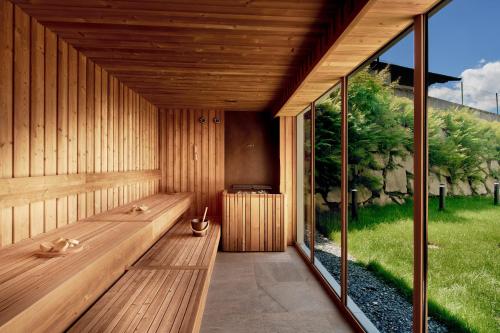 a sauna with a bench and a large window at ever grün KAPRUN in Kaprun