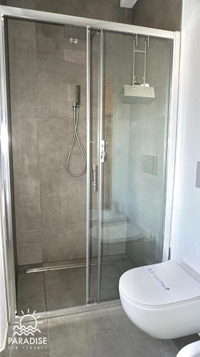 a shower with a glass door in a bathroom at Paradise Sea Terrace in Monopoli