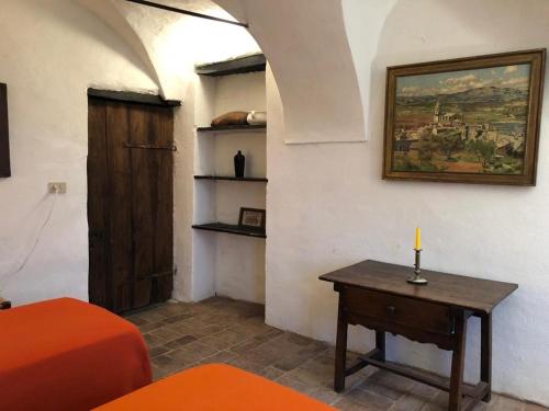 a room with a table with a candle and a painting at A Panoramic Retreat in Baiardo
