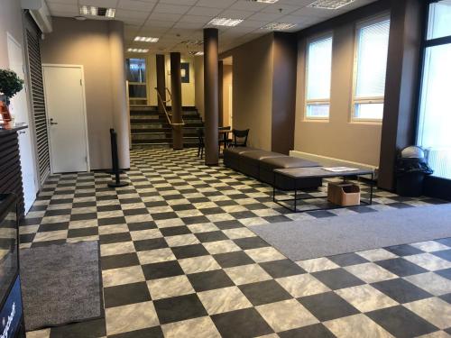 a waiting room with a checkered floor at West Side Hotel in Turku