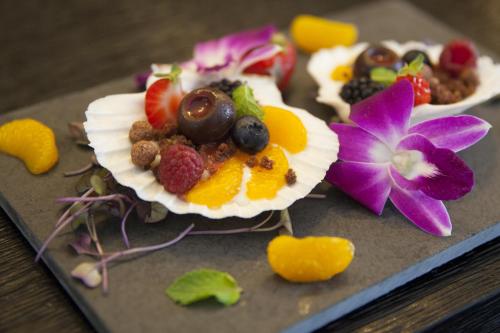 a plate of food with fruit and nuts on it at Hotel Pałac Jugowice in Wałbrzych