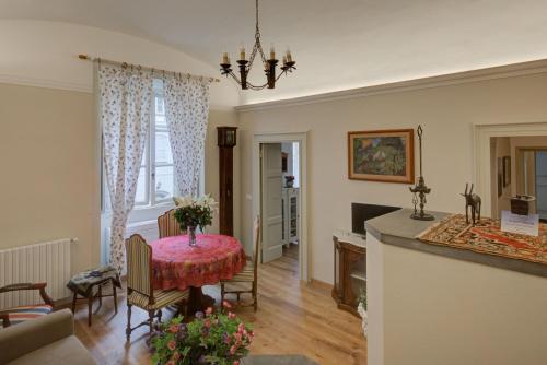 a living room with a table and a kitchen at Apartment Vespucci- quite Historic Palace in Florence