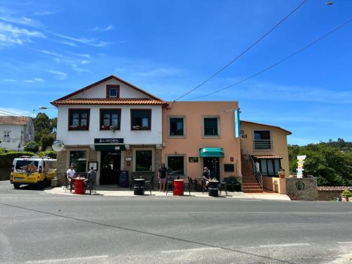 a building on the corner of a street with at A cochera hostel in Ferrol