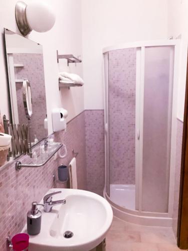 a bathroom with a shower and a white sink at B&B MaryJosè in Trapani