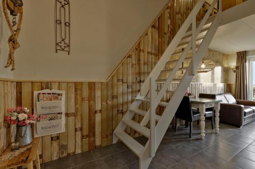a staircase in a living room with wooden walls at Wolfsveld - dicht bij strand en duinen! in Castricum