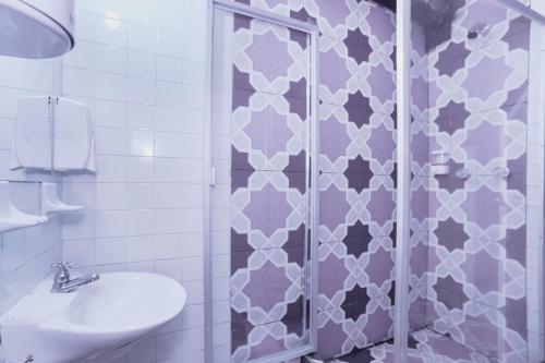 a bathroom with a shower and a sink at ApartaSuites & Hotel Bogota Suamox in Bogotá