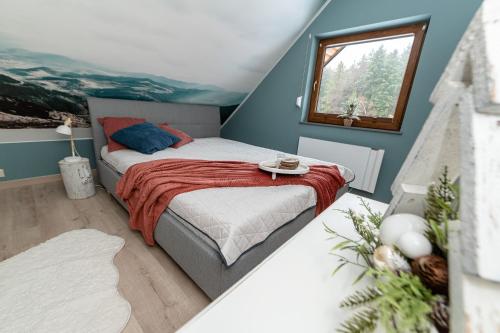 a bedroom with a bed and a window at Domek OlimpijSki SZCZYRK in Szczyrk