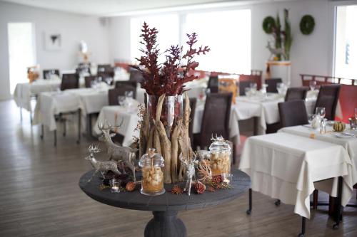 a table with christmas decorations on it in a restaurant at Hotel Rischli in Sörenberg