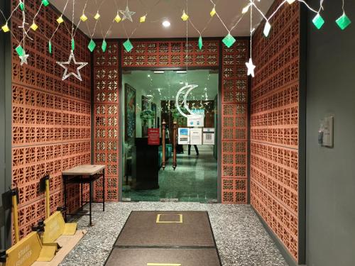 a hallway with red brick walls with a star decoration at Studio 14 Vacation with Pool in Shah Alam City in Shah Alam